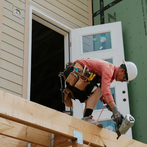 Crew member securing framing near an exterior doorway