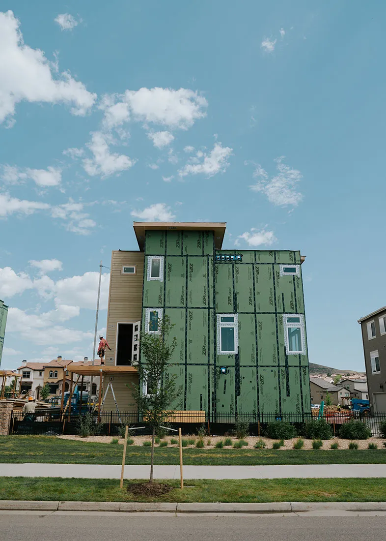 Exterior view of a multi-story home wrapped and ready for the next phase of construction