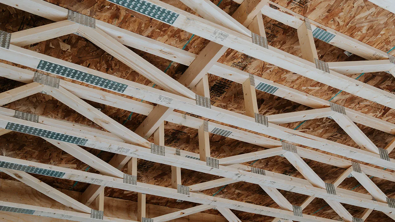 Close-up of installed roof trusses inside a framed structure